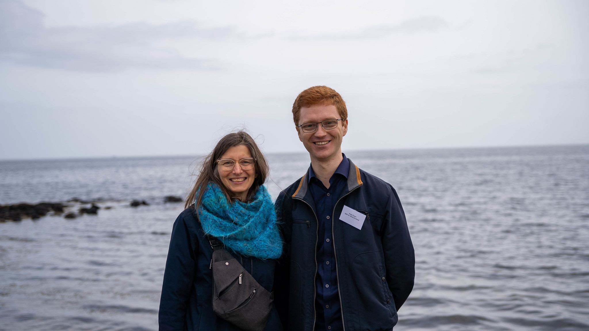 Ariane Burgess MSP on the left and Ross Greer MSP on shore of Lamlash Bay