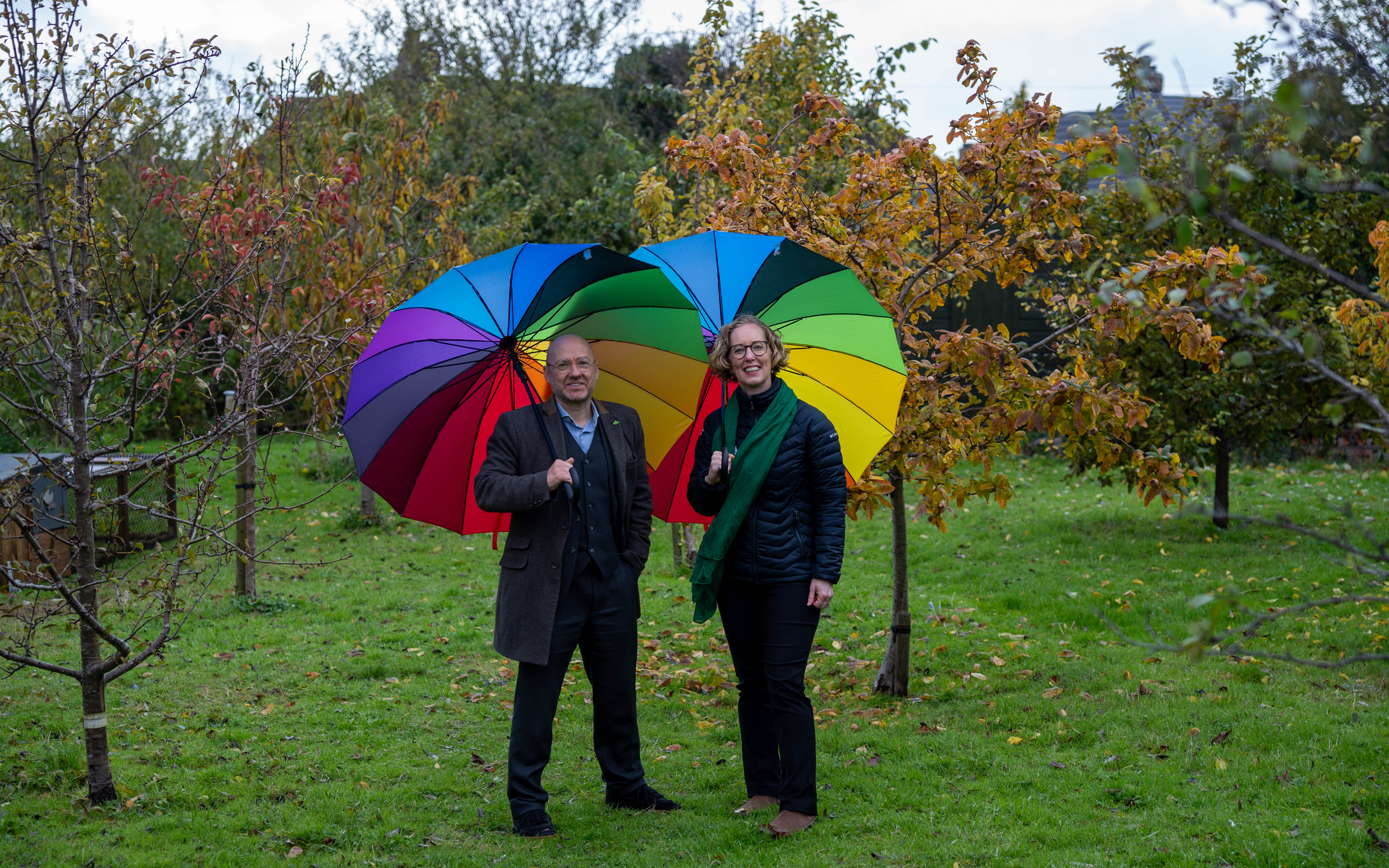 Patrick Harvie and Lorna Slater with rainbow umbrellas