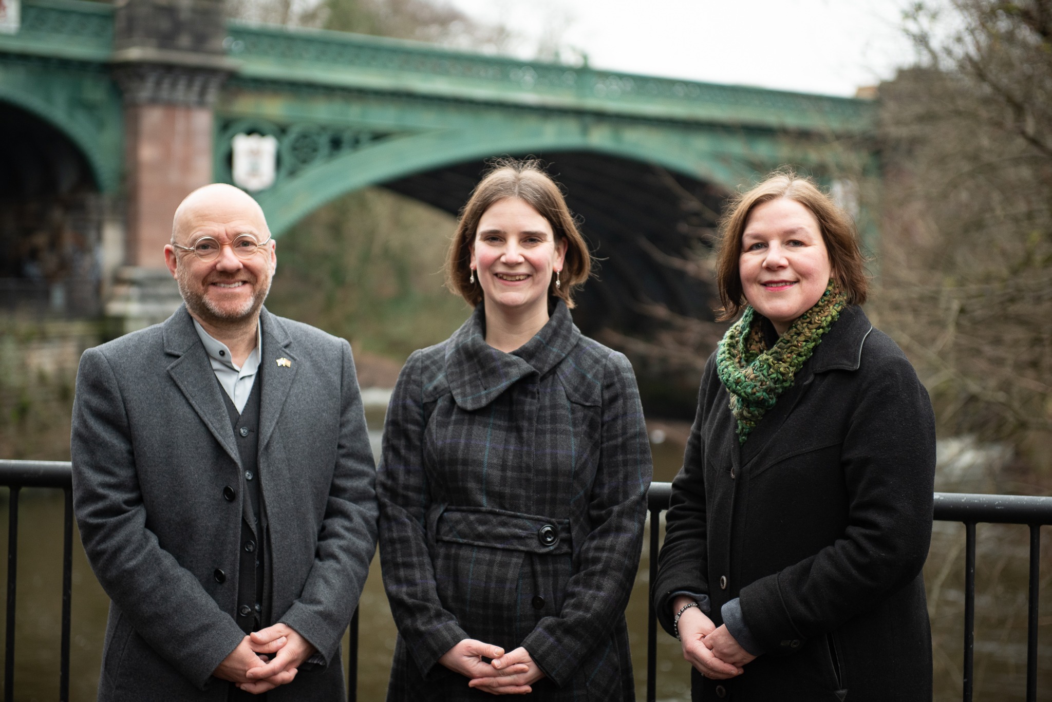 Image of Patrick Harvie, Seoand Hoy, and Martha Wardrop standing in front of a bridge in Hillhead