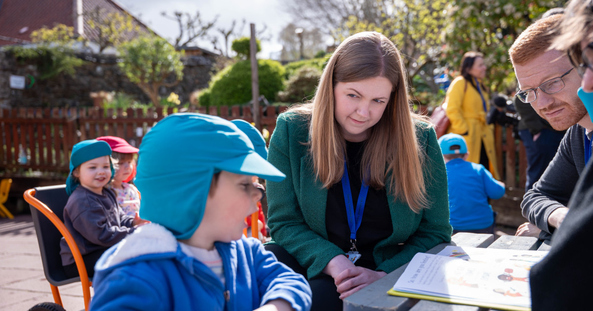 Gillian Mackay and Ross Greer on a visit to meet with nursery pupils and staff, sitting in the garden