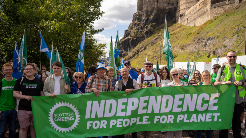 Members of the Green Bloc with a banner which reads, Independence; For People. For Planet.