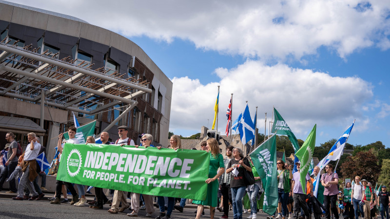 Green members march past the Scottish Parliament for an independent Scotland in the EU